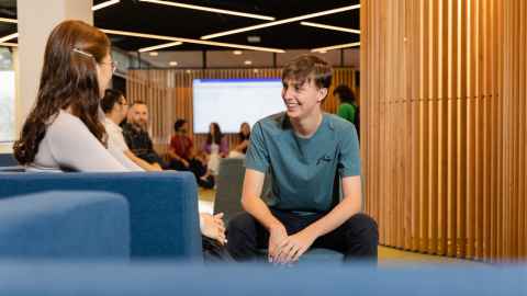 Two students talking in the General Library Student Hub